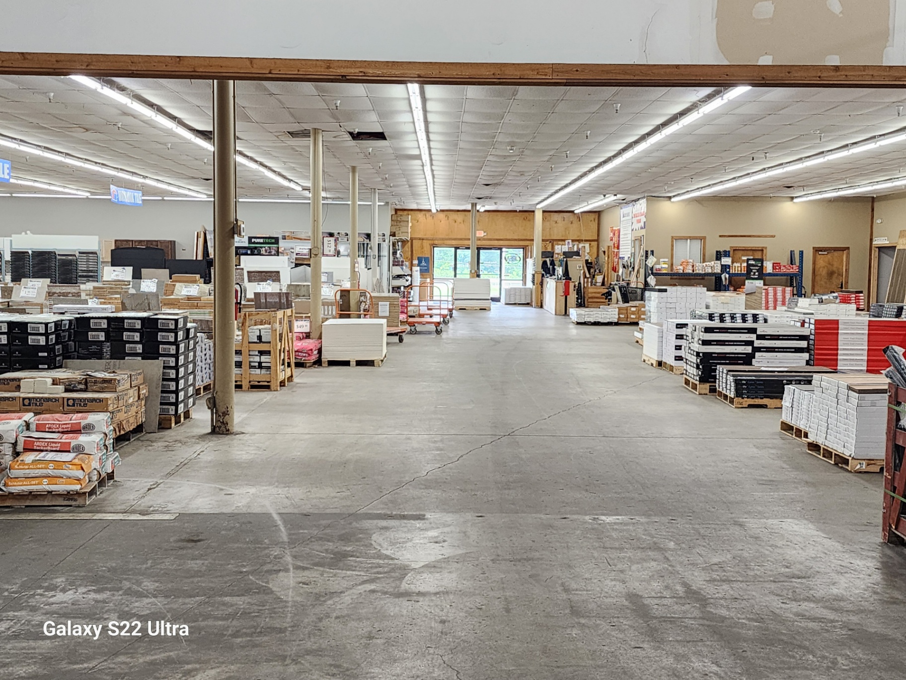 Factory Surplus warehouse aisle with in-stock flooring inventory
